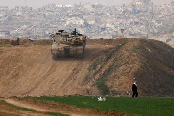 An Israeli tank manoeuvres near the Israel-Gaza border in southern Israel, December 27, 2023.