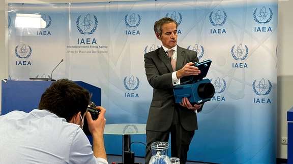 International Atomic Energy Agency Director General Rafael Grossi presents a surveillance camera at the agency's headquarters during a news conference in Vienna, Austria, December 17, 2021.