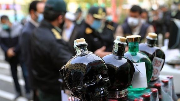 Authorities display confiscated bootleg liquor. (File photo)