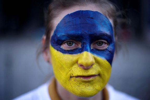 A woman with colors of the Ukrainian flag painted on her face in London. February 27, 2022