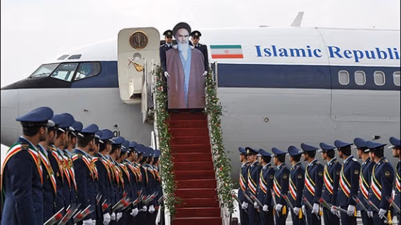 A re-enactment of Khomeini's arrival with a strange cardboard cutout. February 2012