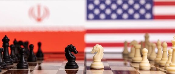 Chess pieces are seen in front of displayed Iran's and US flags in this illustration taken January 26, 2022.