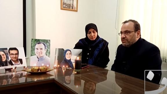 Assadi Lari family during their interview with photos of their children.