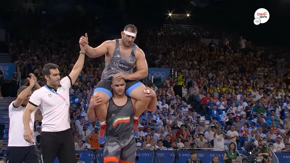 Iran's Mirzadeh lifts Azerbaijan's Iranian wrestler Shariati on his shoulders