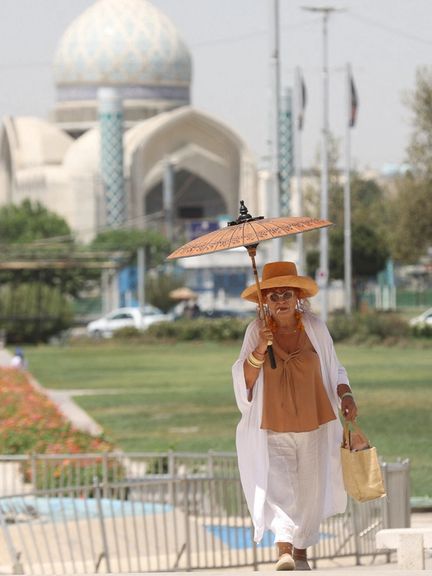 A woman walks in a street during the heat surge in Tehran, Iran, August 2, 2023.