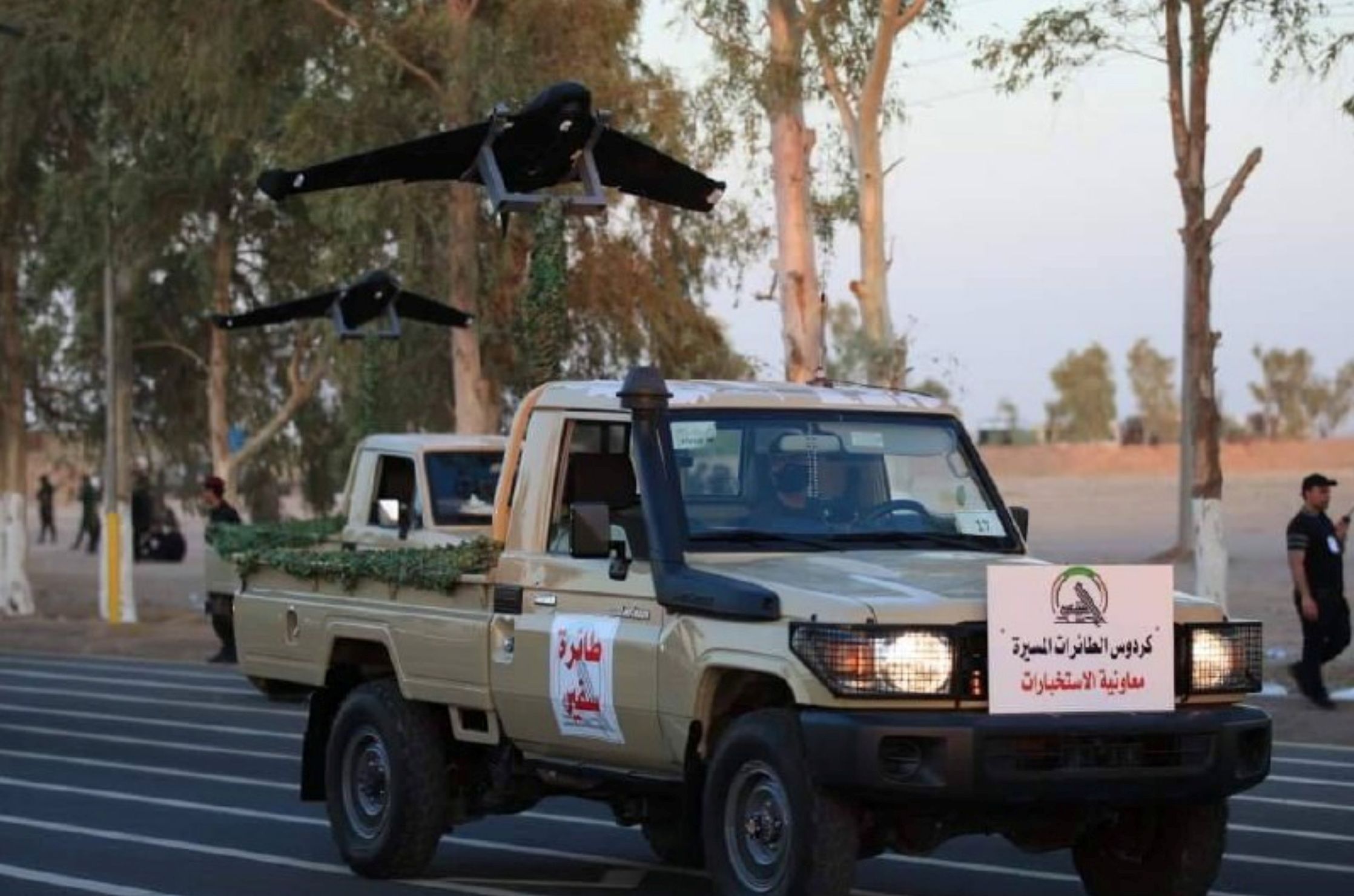 Members of Iraqi Popular Mobilization Forces (PMF) take part in a military parade in Diyala province Iraq, June 26, 2021. Media Office PMF Handout via REUTERS