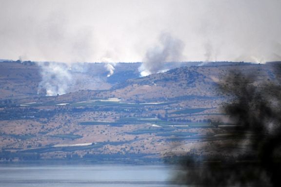Smoke rises over the Israeli-occupied Golan Heights and behind the Sea of Galilee, after Lebanon's Hezbollah said it launched more than 200 rockets and a swarm of drones at Israeli military sites, as seen from northern Israel July 4 2024.