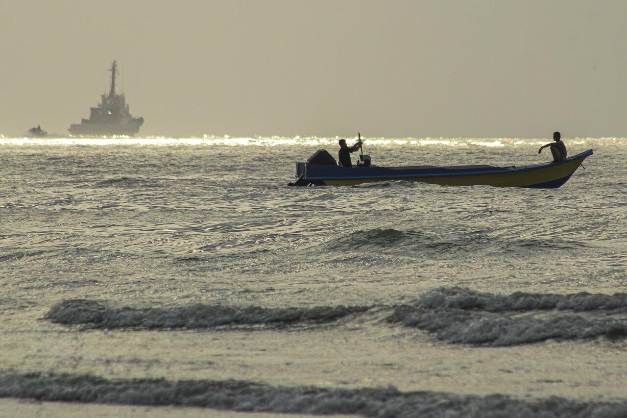 Early morning light shines on the Strait of Hormuz and vessels, as seen from Iran's Persian Gulf port city of Bandar Abbas, July 27, 2026