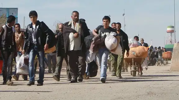 A group of Afghan migrants at the border with Iran