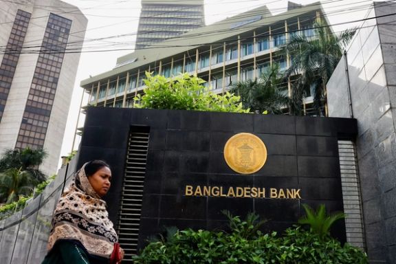 A woman passes by Bangladesh's central bank in Dhaka, Bangladesh, July 19, 2023.