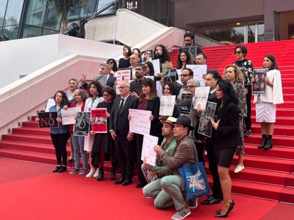 A group of artists at the Cannes Film Festival holding placards in protest to the Islamic Republic’s executions