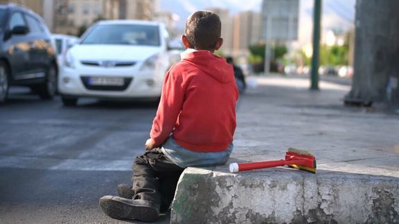 A child laborer sits alone on a street in Tehran, Iran. (File photo)