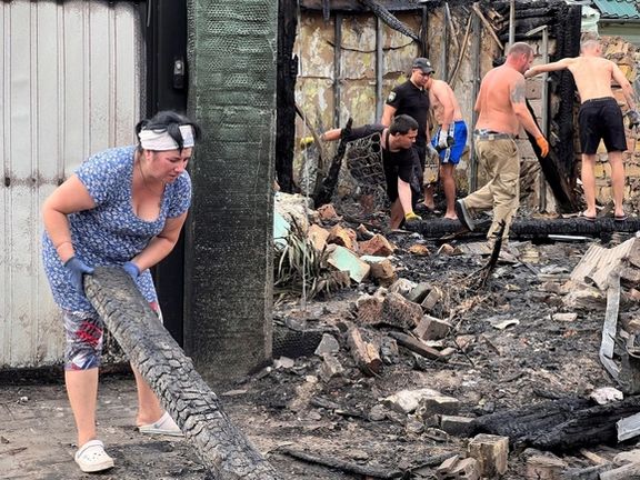 Local residents remove debris from buildings damaged by a Russian missile strike in the village of Tarasivka in Kyiv region Ukraine August 30, 2023.