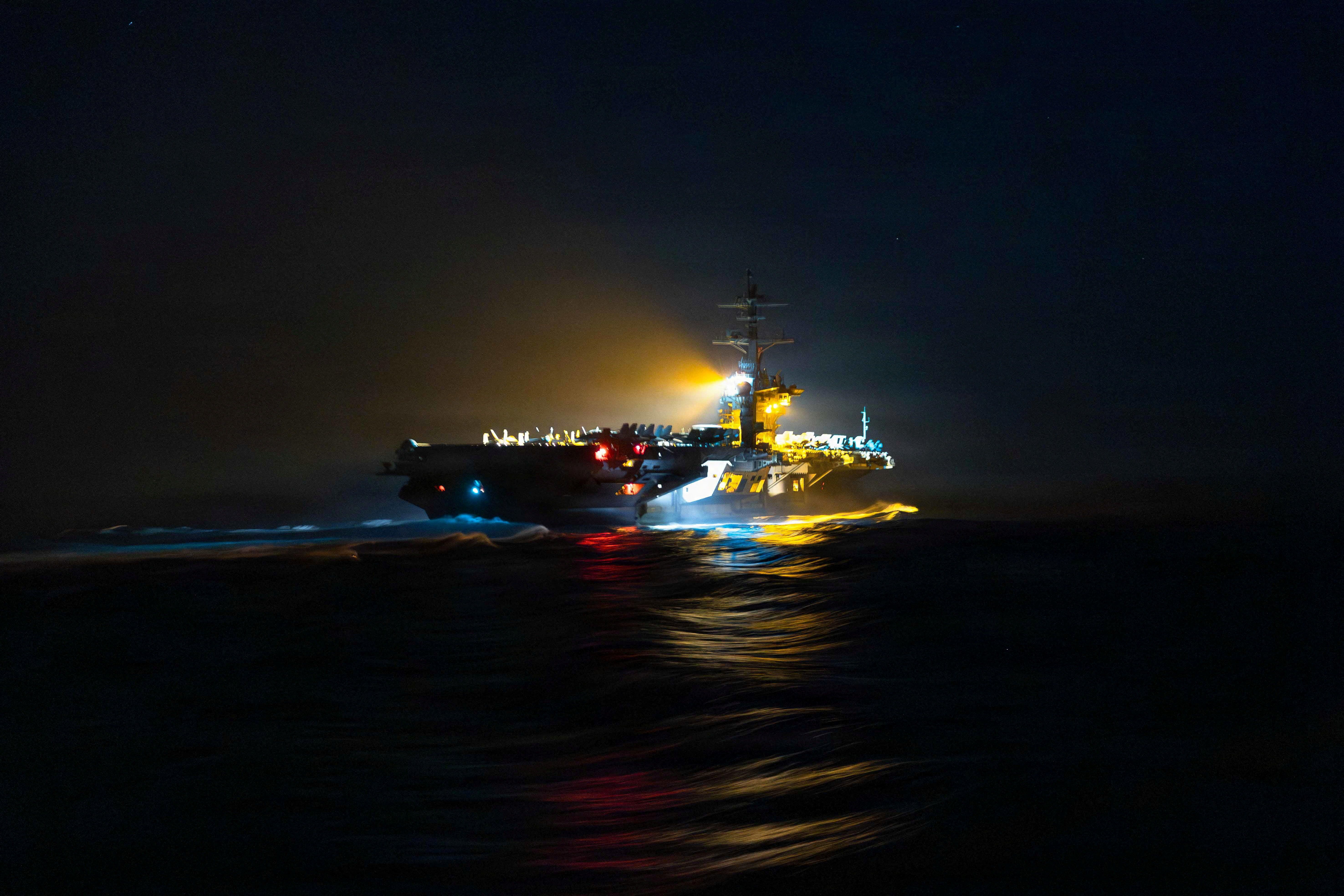 The Nimitz-class aircraft carrier USS Abraham Lincoln departs following a replenishment-at-sea during the Operation Epic Fury attack on Iran at an undisclosed location, March 18, 2026. 