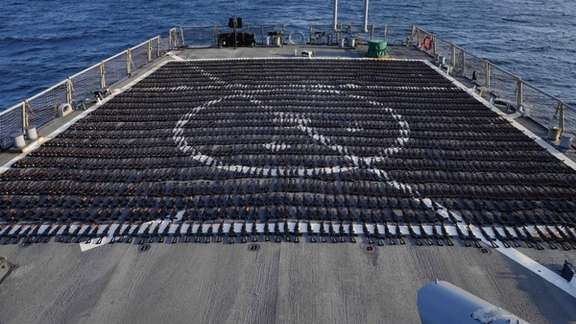Thousands of AK-47 assault rifles sit on the flight deck of guided-missile destroyer USS The Sullivans (DDG 68) during an inventory process on January 7, 2023.