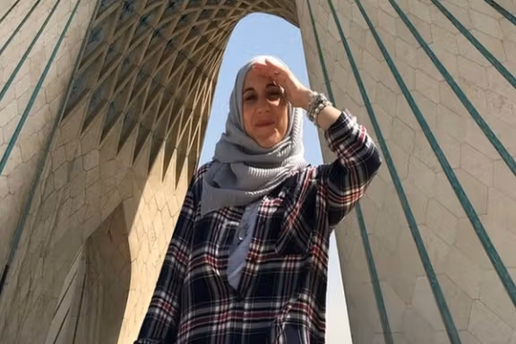 Catherine Perez-Shakdam in a photo next to Tehran's iconic Azadi tower