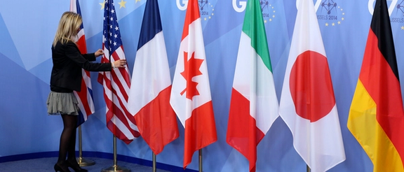 File Photo: An official adjusts flags during the G7 summit at the European Council building in Brussels June 5, 2014.