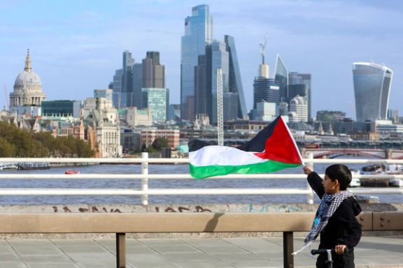 A boy holds a Palestinian flag as demonstrators protest in solidarity with Palestinians in Gaza, amid the ongoing conflict between Israel and the Palestinian Islamist group Hamas, in London, Britain, October 28, 2023