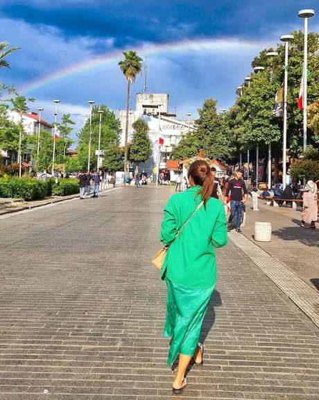 An Iranian woman defying mandatory hijab rules