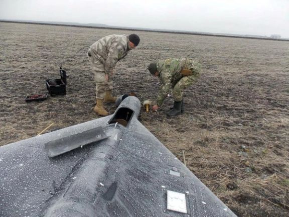 Members of a Ukrainian police demining unit remove a warhead from a Russian kamikaze drone amid Russia's attack on Ukraine in an unknown location in Ukraine, in this handout picture released January 26, 2024.