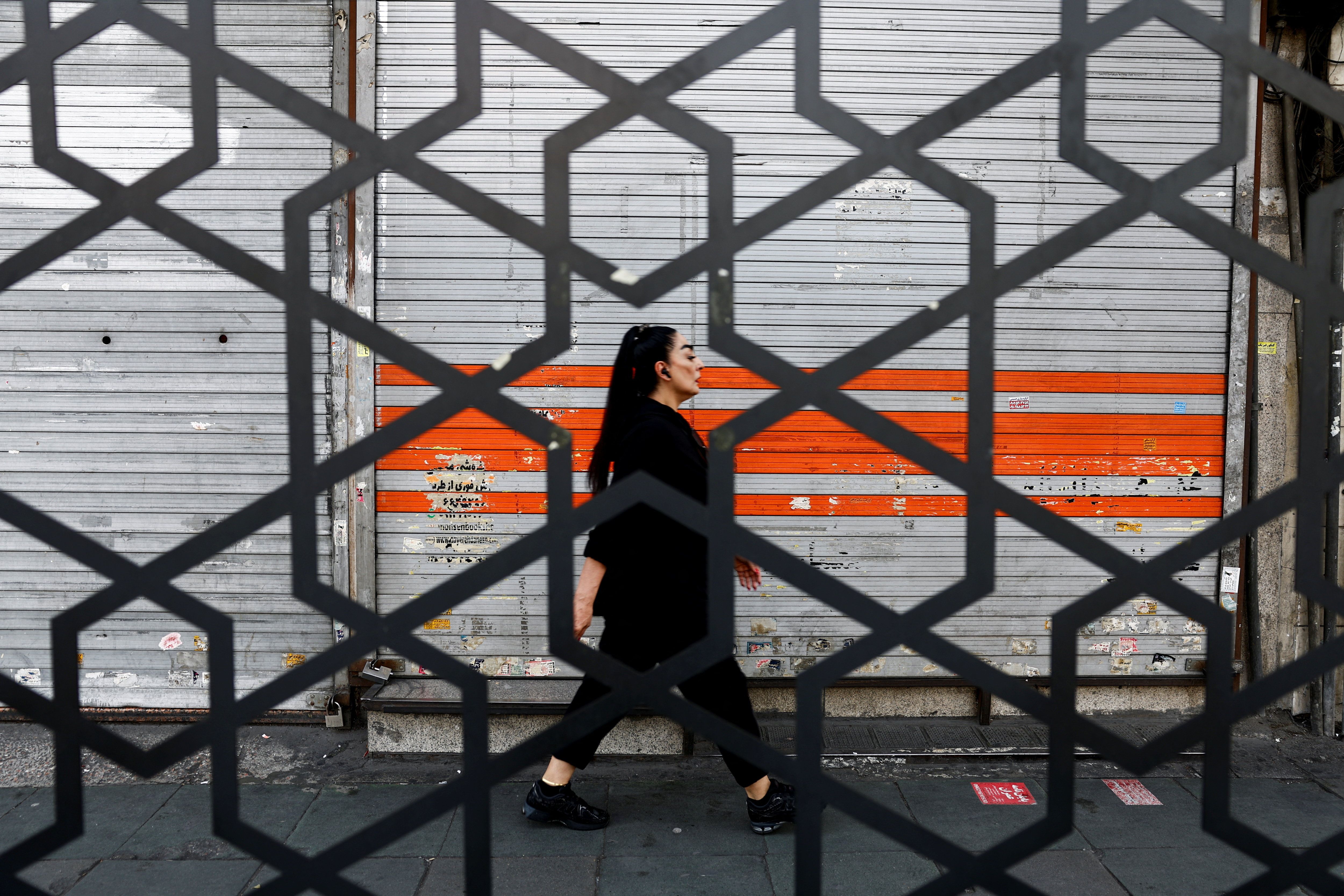 A woman walks on a street in Tehran, Iran, March 22, 2026. 