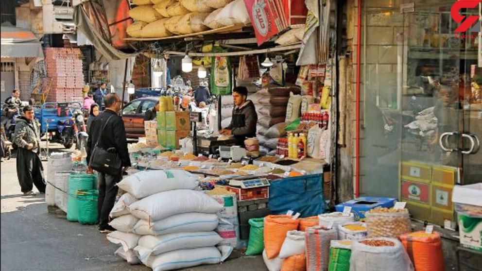 Shopper outside a food store in Iran. Undated