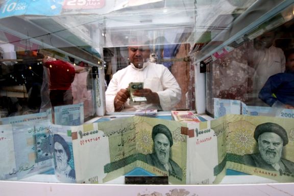 A man counts Iranian rials at a currency exchange shop in Basra, Iraq, November 3, 2018.