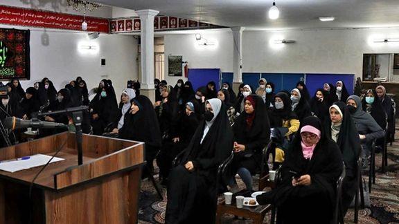 A group wedding of Afghans in Iran. Women sit separate from the men.