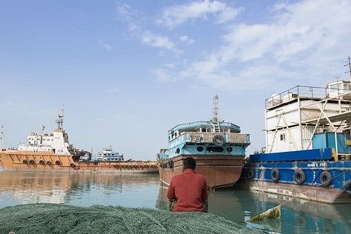 A typical small ship at anchor in an Iranian port.