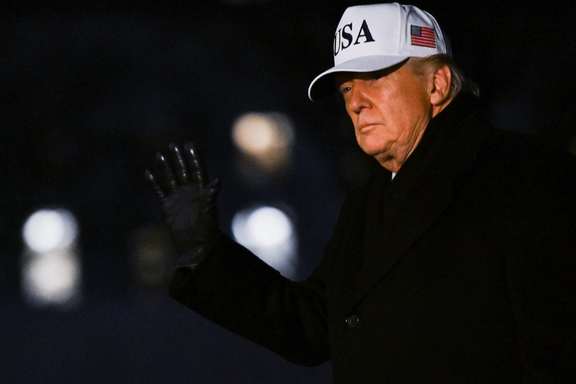 US President Donald Trump waves as he walks upon arrival on the South Lawn of the White House in Washington, January 27, 2026.