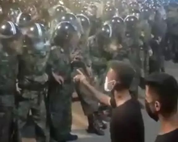 Protesters in Iran confronting a throng of security forces