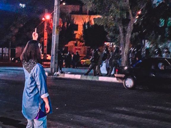 A female protester defying anti-riot troops in Iran. Undated