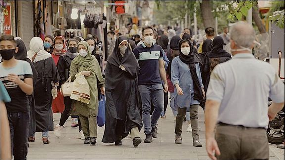 People walking in street in Tehran . Undated