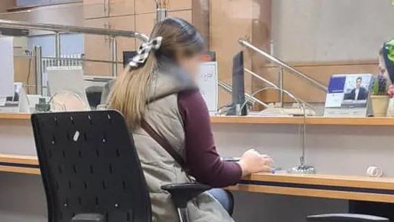 An Iranian woman without hijab at a bank