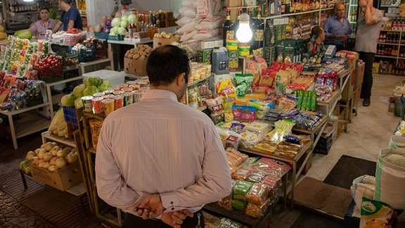 An Iranian man shopping at a bazaar