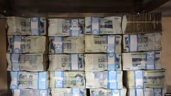 Pile of Iranian currency that has lost its value eightfold in the past 4 years.