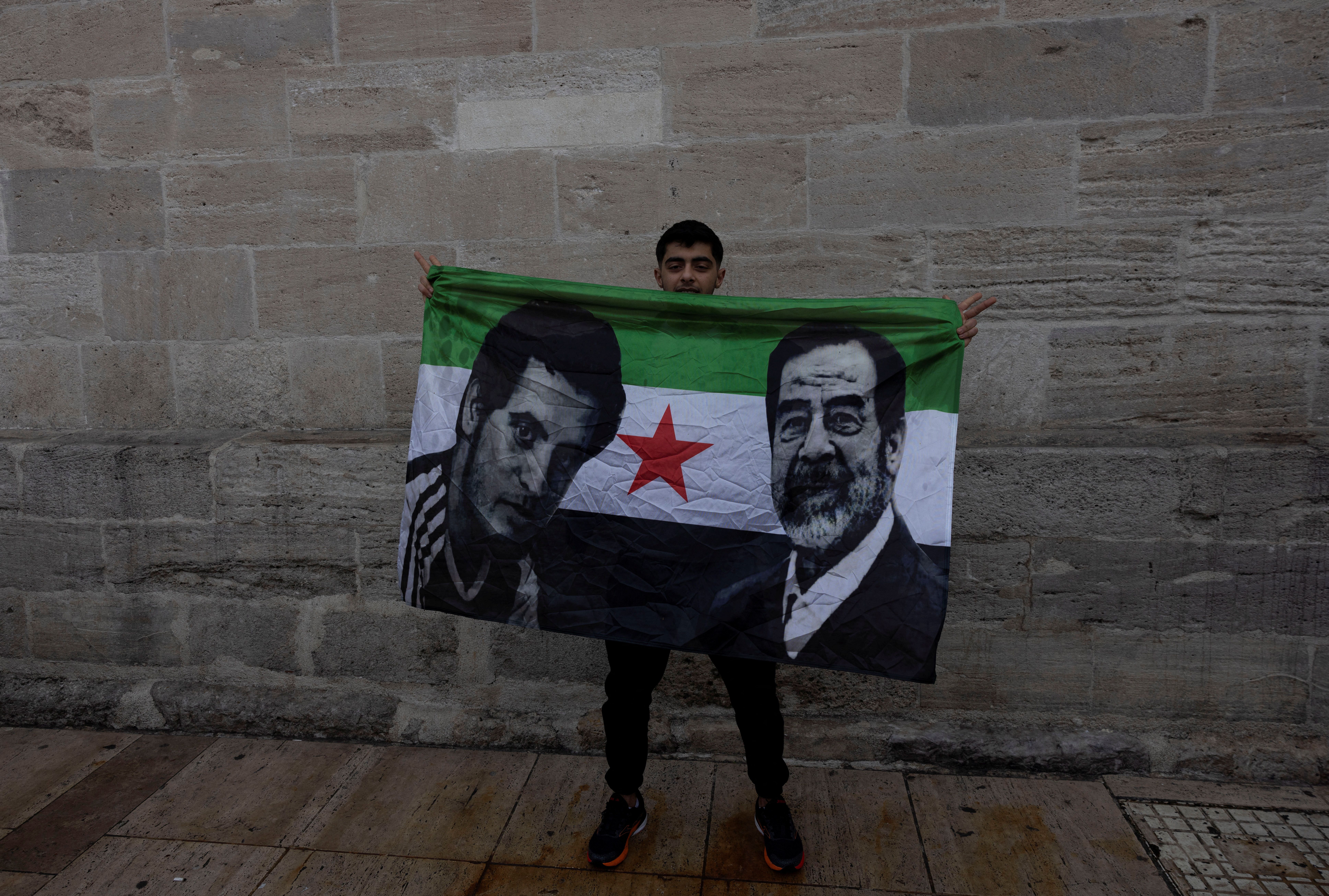 A Syrian living in Turkey celebrates with a flag after Syrian rebels announced that they have ousted President Bashar al-Assad, in front of the Fatih Mosque in Istanbul, Turkey, December 8, 2024.