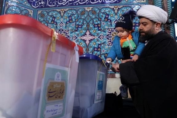 An Iranian cleric casts his vote during parliamentary elections at a polling station in Tehran, Iran, March 1, 2024.