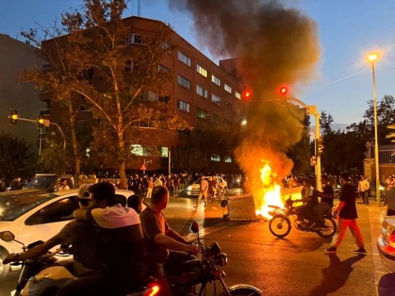 A police motorcycle burns during a protest over the death of Mahsa Amini September 2022