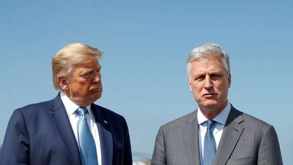 Former US President Donald Trump listens to his newly announced White House national security adviser Robert O'Brien speak to reporters after he named O'Brien as his fourth national security adviser at Los Angeles International Airport in Los Angeles, California, September 18, 2019.