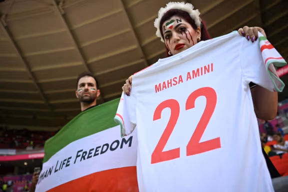 Iranian fans displaying messages in support of women and freedom during Iran's match against Waled on November 25, 2022