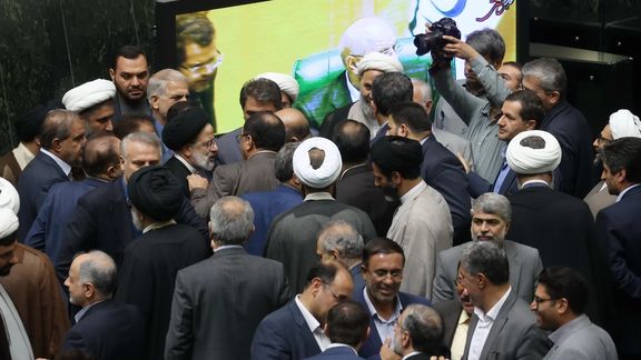 Iranian President Ebrahim Raisi among lawmakers at the parliament in June 2023