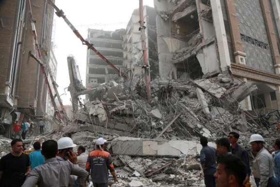 Rescue crews work at the site of a ten-storey building collapse in Abadan, Iran May 23, 2022.