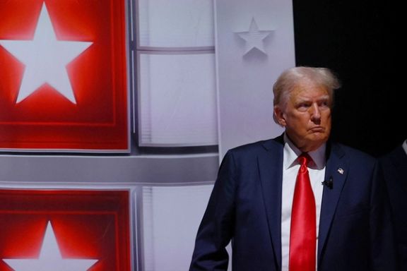 Former US President Donald Trump walks back to his podium after a commercial break during a debate with President Joe Biden , June 27, 2024.