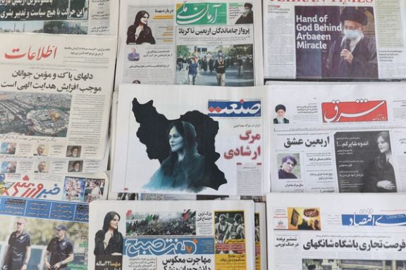 Newspapers with a cover picture of Mahsa Amini, whose death at the hands of the Islamic republic's 'morality police' (September 18, 2022)