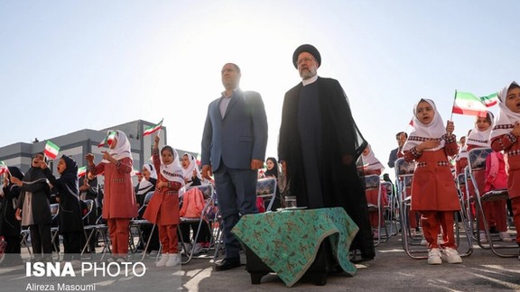Iran’s Education Minister Reza Morad Sahraei (left) and President Ebrahim Raisi among schoolgirls during a ceremony in Tehran