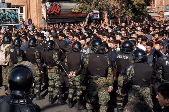 Iranian anti-riot special forces standing in front of protesters