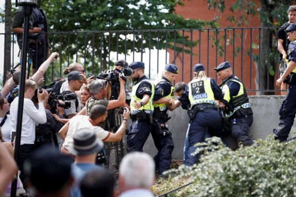 Police officers intervene after people's reaction as demonstrators burn the Quran (not pictured) outside Stockholm's central mosque in Stockholm, Sweden June 28, 2023.