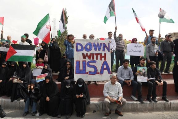 A man holds an anti-US banner during a rally, as people gather in support of Gaza, in Tehran, Iran April 11, 2025.