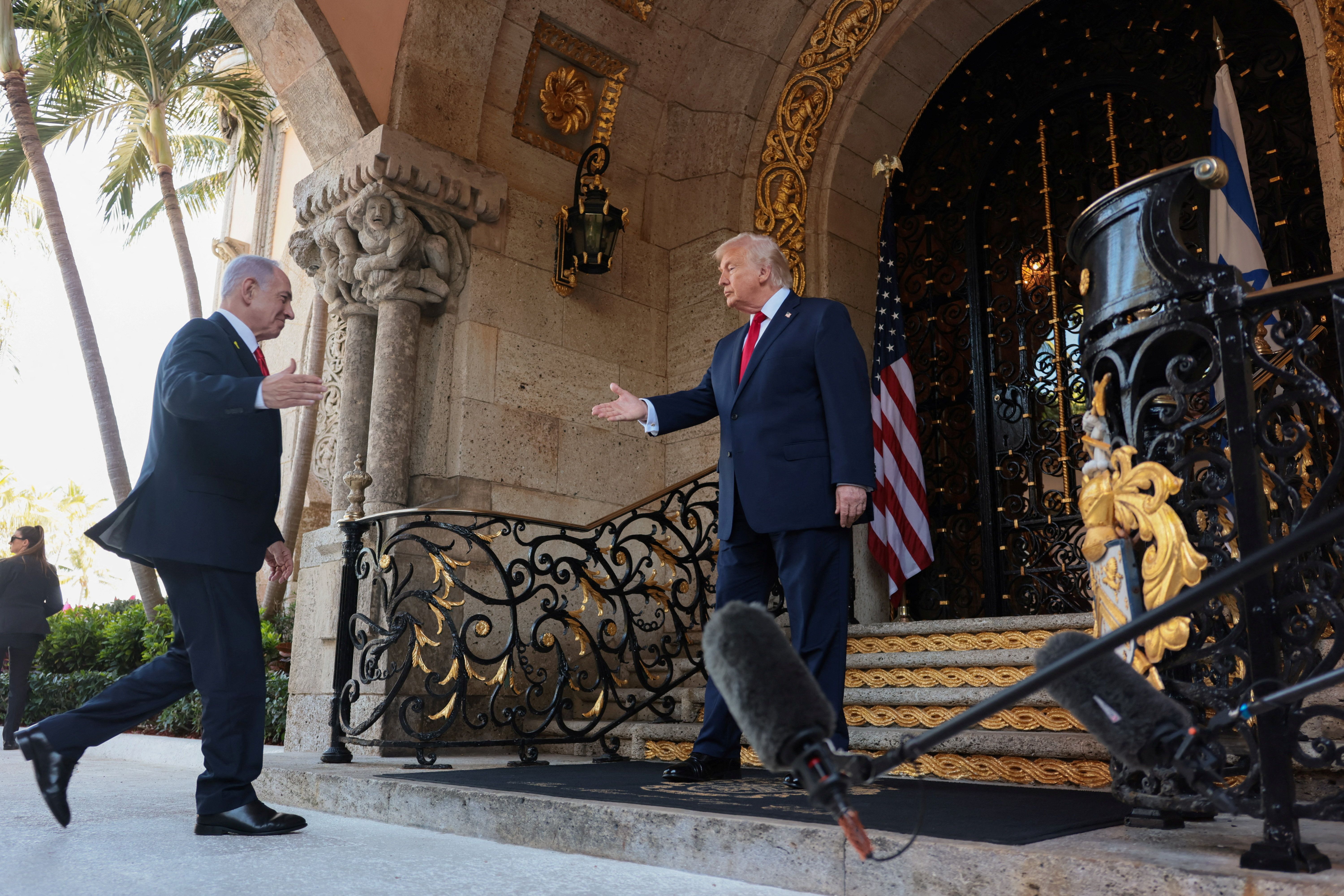 US President Donald Trump greets Israeli Prime Minister Benjamin Netanyahu upon arrival for meetings at Trump's Mar-a-Lago club in Palm Beach, Florida, December 29, 2025. 